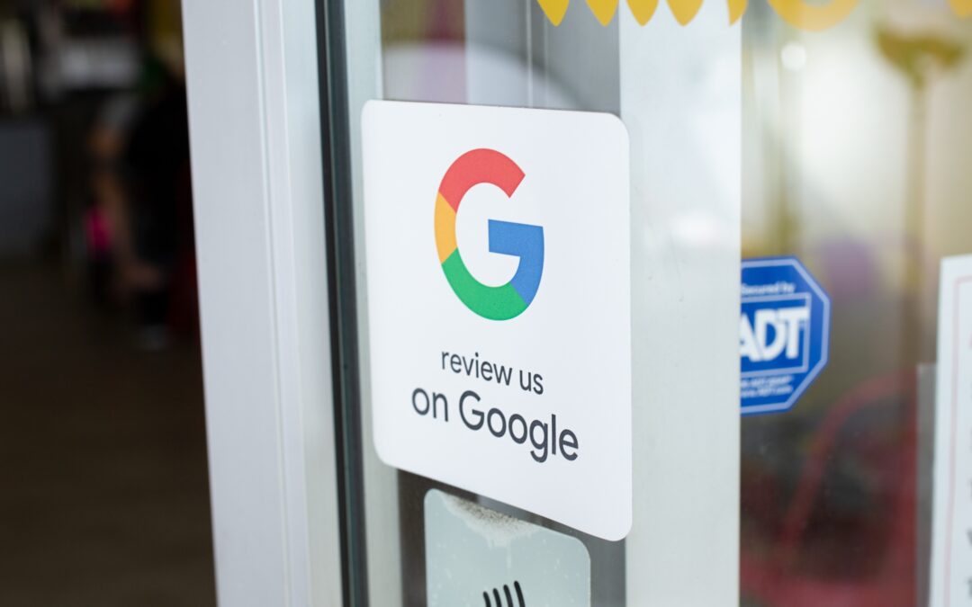 A sign on a glass door displaying the Google logo